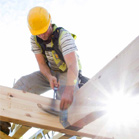 construction worker hammering roof